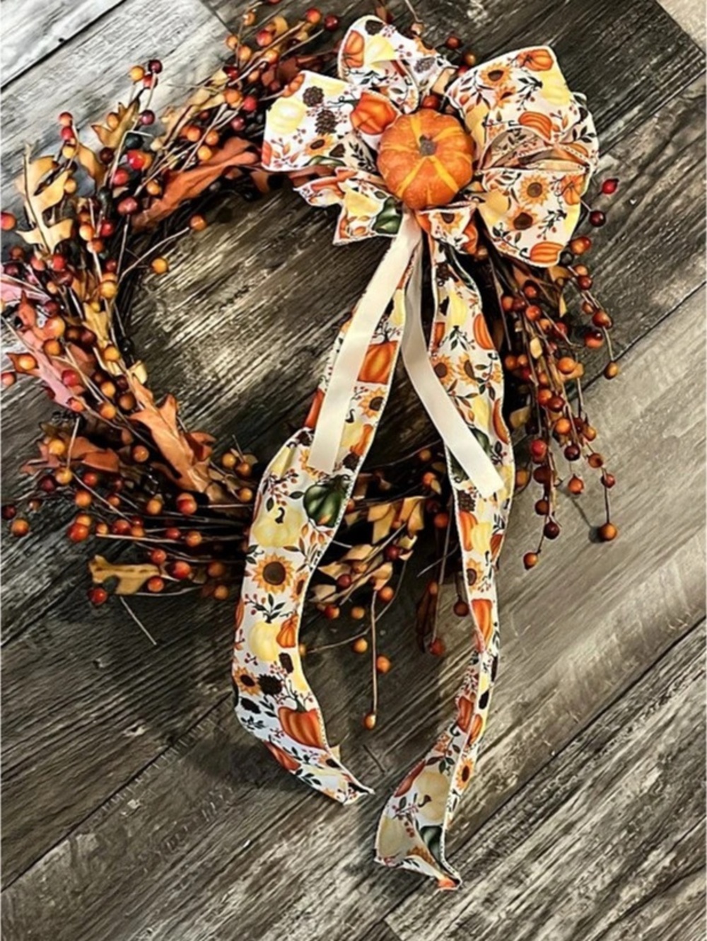 Fall hanging wreath with pumpkins and bow